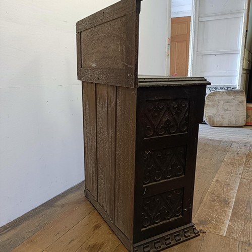 887 - A carved oak cupboard, 62 cm wide