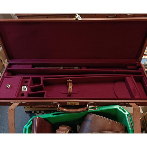 812 - A leather gun case, two other gun cases, a cartridge belt, and two cartridge bags