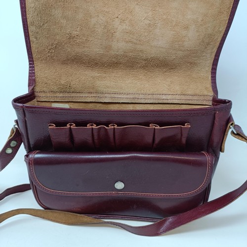 812 - A leather gun case, two other gun cases, a cartridge belt, and two cartridge bags