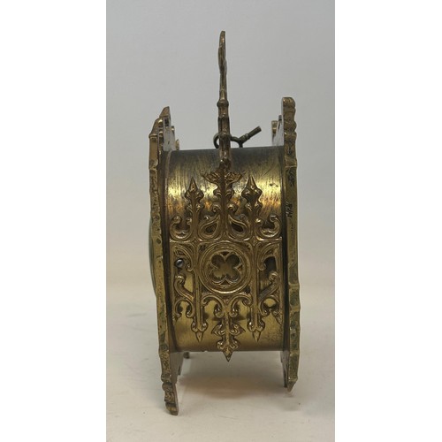 822 - A carriage clock, in a Gothic brass case, 20 cm high