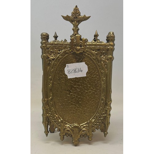 822 - A carriage clock, in a Gothic brass case, 20 cm high