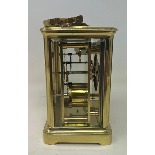 824 - A carriage clock, in a brass and glass case, 18 cm high