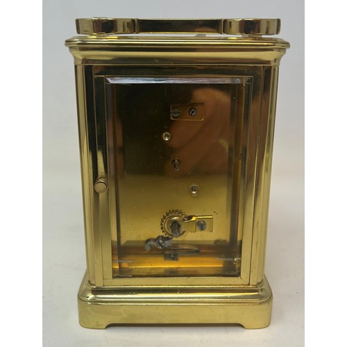 824 - A carriage clock, in a brass and glass case, 18 cm high