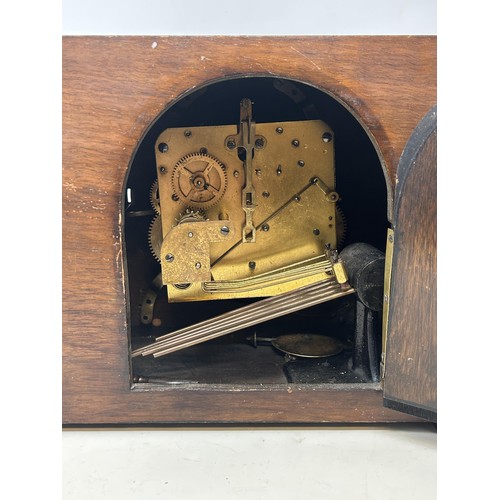 829 - An Art Deco mantel clock, with a triple train movement, in a walnut case, 28 cm wide