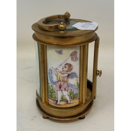 830 - A carriage clock, in an oval brass and glass case, 10 cm high, and a miniature carriage clock, 7 cm ... 