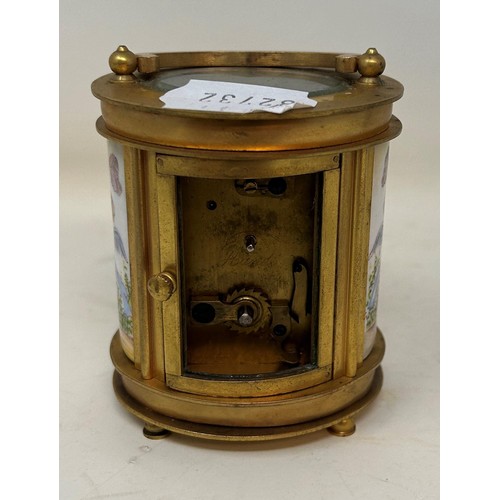 830 - A carriage clock, in an oval brass and glass case, 10 cm high, and a miniature carriage clock, 7 cm ... 