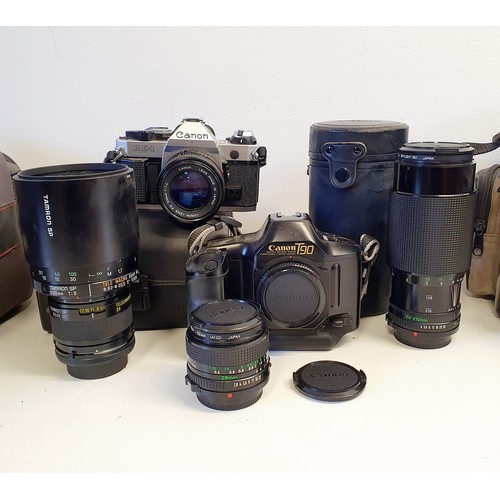 169 - A Canon AE-1 Program camera, a Canon T90 camera, and assorted lenses