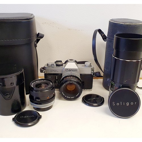 166 - A Canon FTb camera, a Canon FD 28 mm lens, another lens, various accessories in a carry case