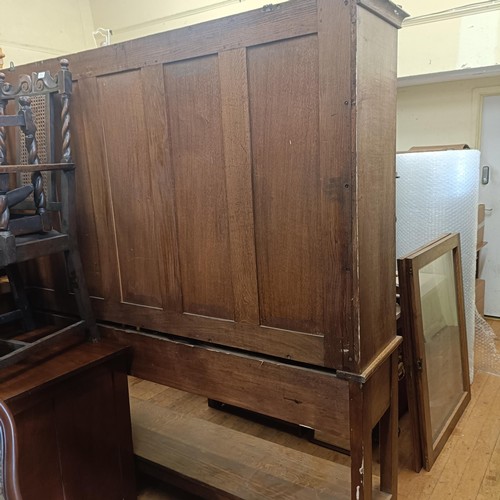 1026 - An oak glazed bookcase, on a stand, 190 cm high x 185 cm wide