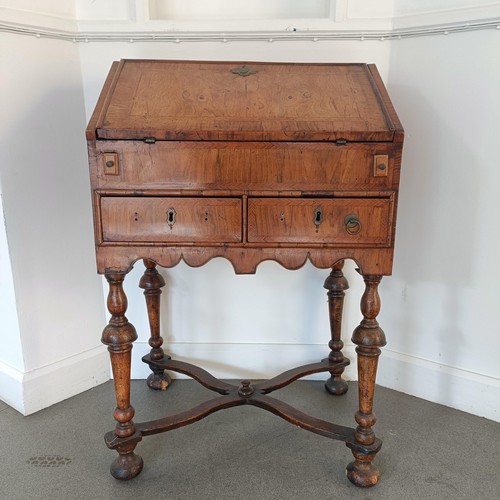 1045 - An 18th century walnut bureau, of small proportions, the hinged top to reveal drawers, pigeon holes ... 