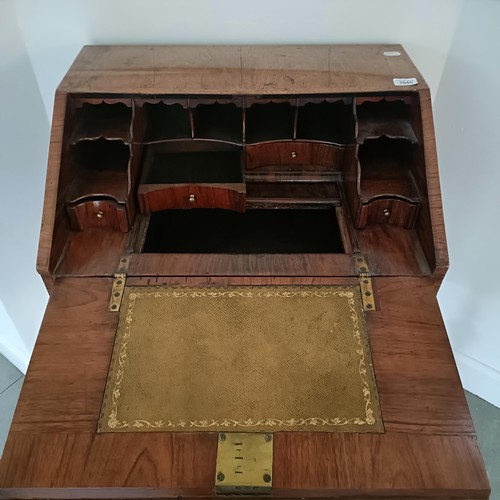 1045 - An 18th century walnut bureau, of small proportions, the hinged top to reveal drawers, pigeon holes ... 