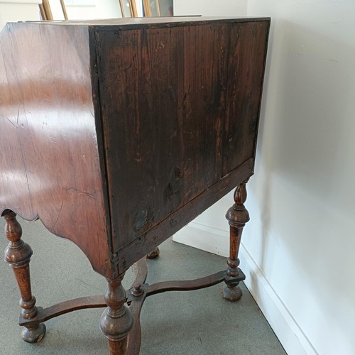 1045 - An 18th century walnut bureau, of small proportions, the hinged top to reveal drawers, pigeon holes ... 