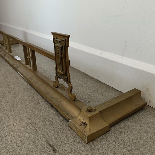 932 - A brass fender, 125 cm high