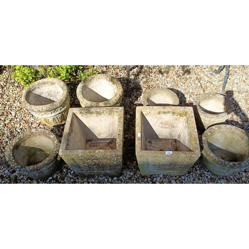 979 - A pair of square composite stone garden urns, 38 cm wide, and six others