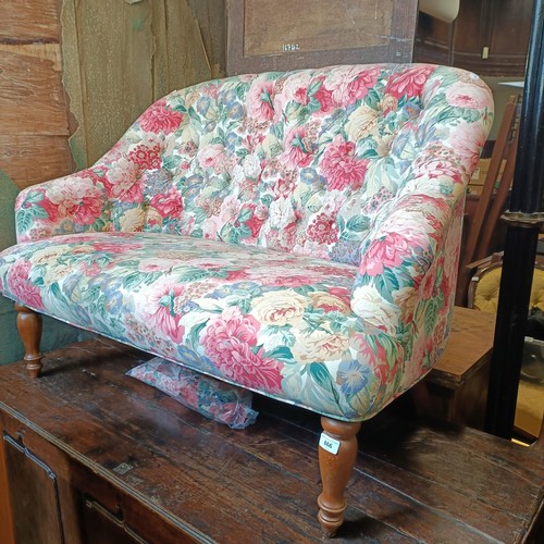 866 - A button back sofa, upholstered in floral fabric, 126 cm wide