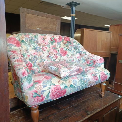 866 - A button back sofa, upholstered in floral fabric, 126 cm wide