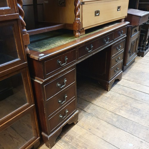 921 - A mahogany pedestal desk, 137 cm wide, a two drawer chest, and three chairs (5)