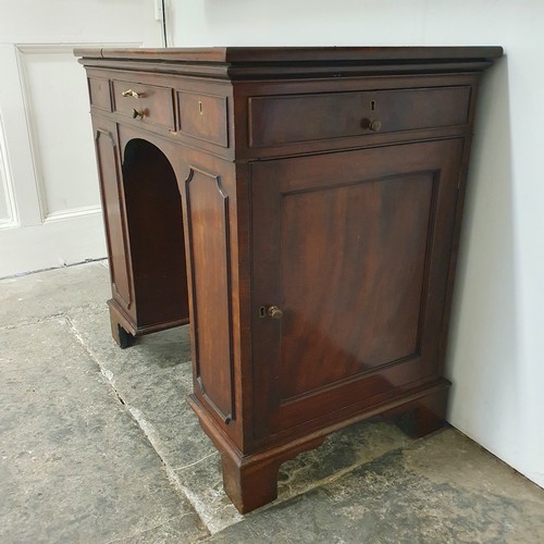 858 - An unusual mahogany kneehole desk, the top having three drawers, with cupboard doors to the side, 84... 