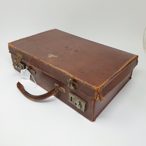 543 - A Leica pocket book, a Leica lens box, a box camera, in a vintage leather suitcase, a Leitz slide pr... 