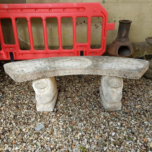 957 - A composite stone garden bench, with supports in the form of lions, 150 cm wide