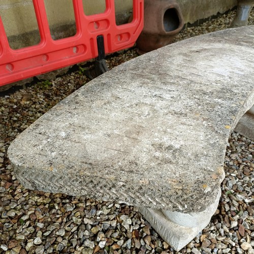 957 - A composite stone garden bench, with supports in the form of lions, 150 cm wide