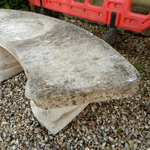 957 - A composite stone garden bench, with supports in the form of lions, 150 cm wide