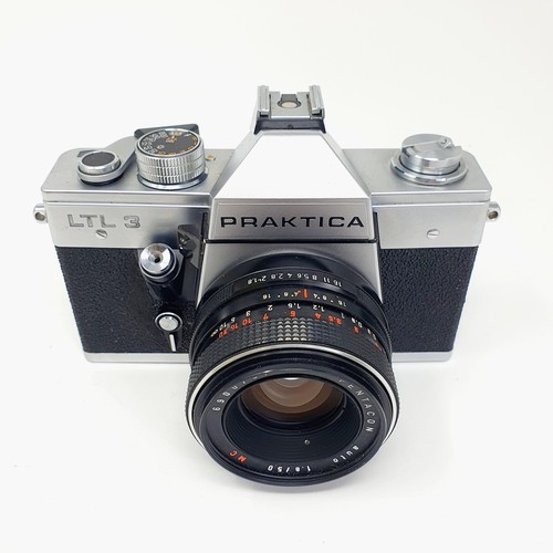 543 - A Leica pocket book, a Leica lens box, a box camera, in a vintage leather suitcase, a Leitz slide pr... 