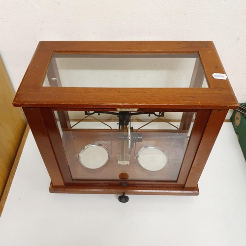 724 - *** Regretfully Withdrawn ****A set of laboratory scales, in a mahogany case, 45 cm wide, five other... 