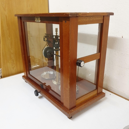 724 - *** Regretfully Withdrawn ****A set of laboratory scales, in a mahogany case, 45 cm wide, five other... 