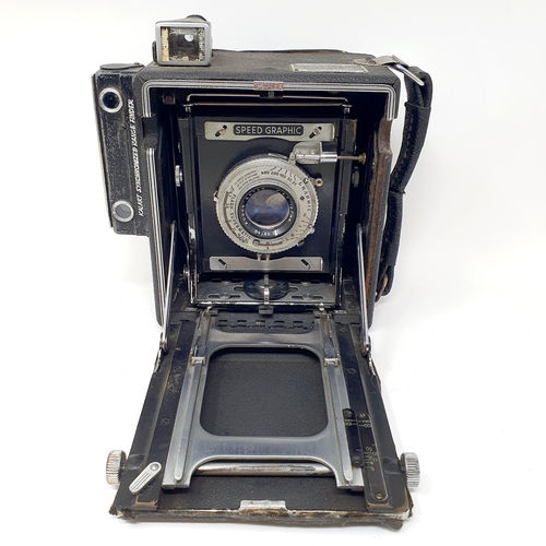 611 - A Graflex Speed Graphic bellows camera, with a Kodak lens, assorted photography equipment, a magic l... 