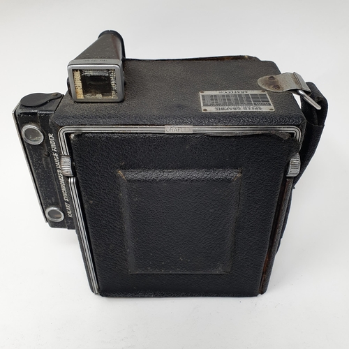 611 - A Graflex Speed Graphic bellows camera, with a Kodak lens, assorted photography equipment, a magic l... 