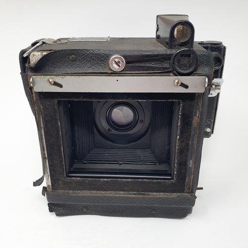 611 - A Graflex Speed Graphic bellows camera, with a Kodak lens, assorted photography equipment, a magic l... 