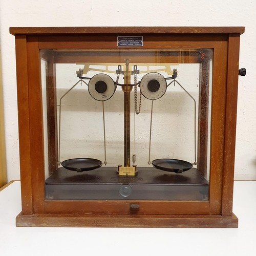 724 - *** Regretfully Withdrawn ****A set of laboratory scales, in a mahogany case, 45 cm wide, five other... 