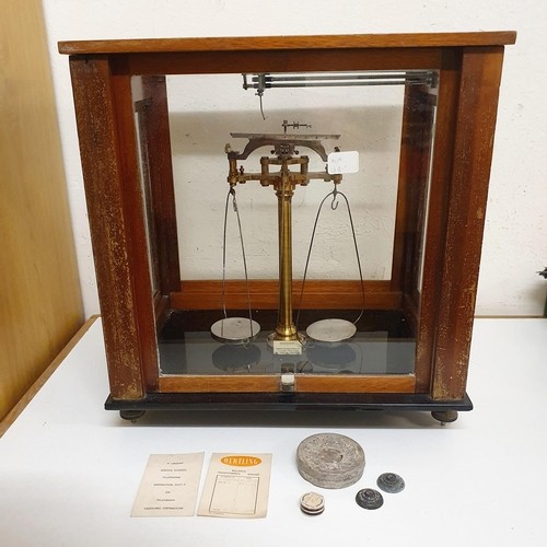 724 - *** Regretfully Withdrawn ****A set of laboratory scales, in a mahogany case, 45 cm wide, five other... 