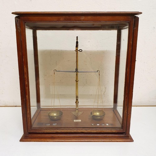 724 - *** Regretfully Withdrawn ****A set of laboratory scales, in a mahogany case, 45 cm wide, five other... 