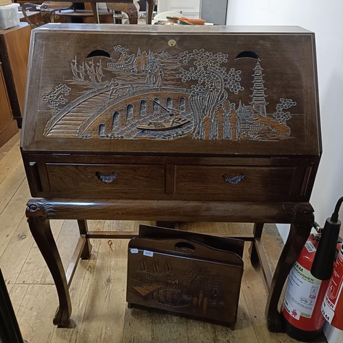 811 - A carved camphorwood trunk, 92 cm wide, a similar bureau, a magazine rack, two coffee tables, and a ... 