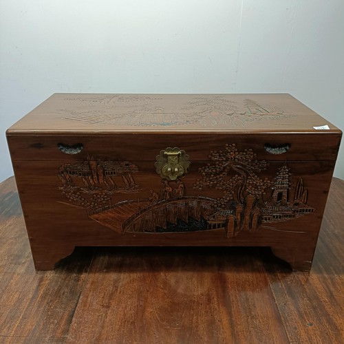 811 - A carved camphorwood trunk, 92 cm wide, a similar bureau, a magazine rack, two coffee tables, and a ... 