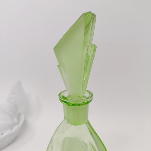 62 - An Art Deco spelter figure of a woman, on a white marble base, 29 cm high, a green glass decanter, s... 