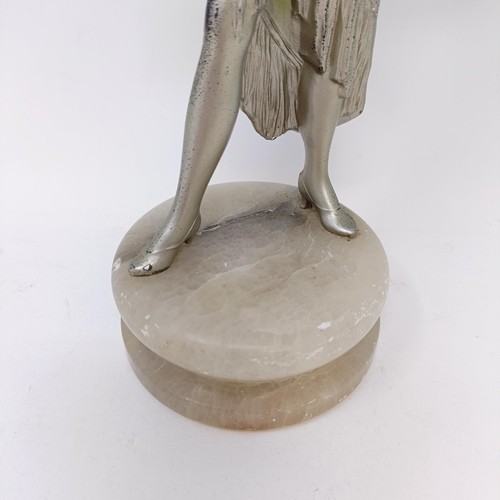 62 - An Art Deco spelter figure of a woman, on a white marble base, 29 cm high, a green glass decanter, s... 