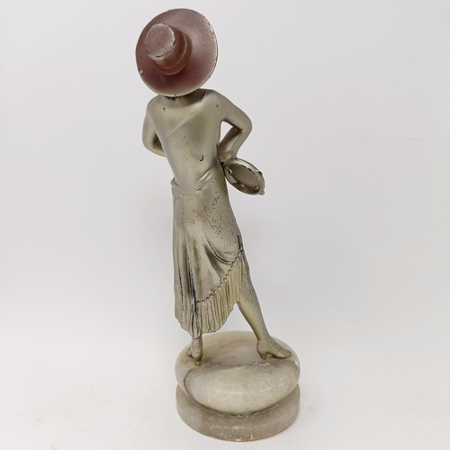 62 - An Art Deco spelter figure of a woman, on a white marble base, 29 cm high, a green glass decanter, s... 