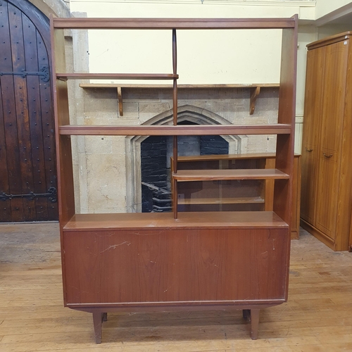 182 - A 1970s teak room divider, the top with open shelves on a base with two sliding doors on square tape... 