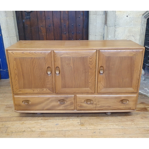 185 - An Ercol elm sideboard, with a blue label, 132 cm wide