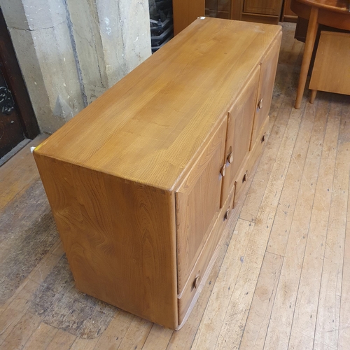 185 - An Ercol elm sideboard, with a blue label, 132 cm wide