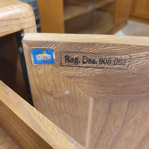 185 - An Ercol elm sideboard, with a blue label, 132 cm wide