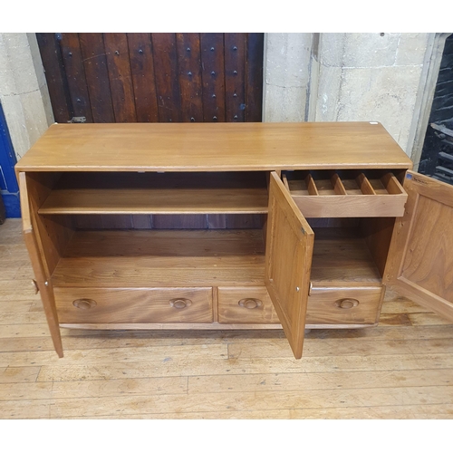185 - An Ercol elm sideboard, with a blue label, 132 cm wide