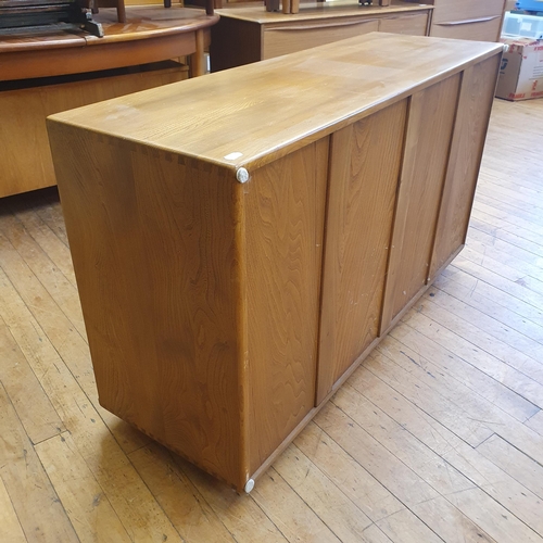 185 - An Ercol elm sideboard, with a blue label, 132 cm wide