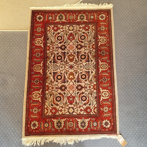 828 - An Azerbaijan cream ground rug, 147 x 102 cm