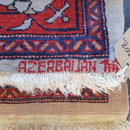 828 - An Azerbaijan cream ground rug, 147 x 102 cm