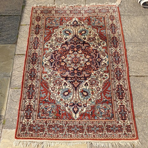 846 - A Lahore red ground rug, 180 x 127 cm