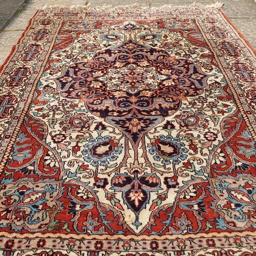 846 - A Lahore red ground rug, 180 x 127 cm